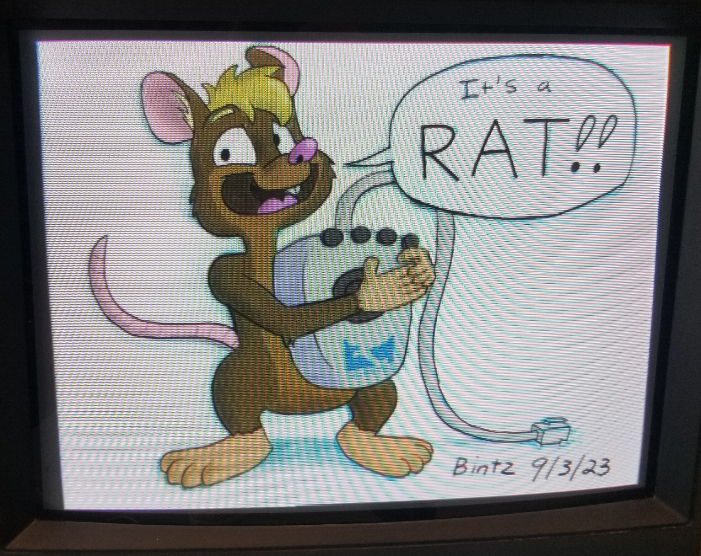 A cartoon rat holding an input device called a Quantel RAT.