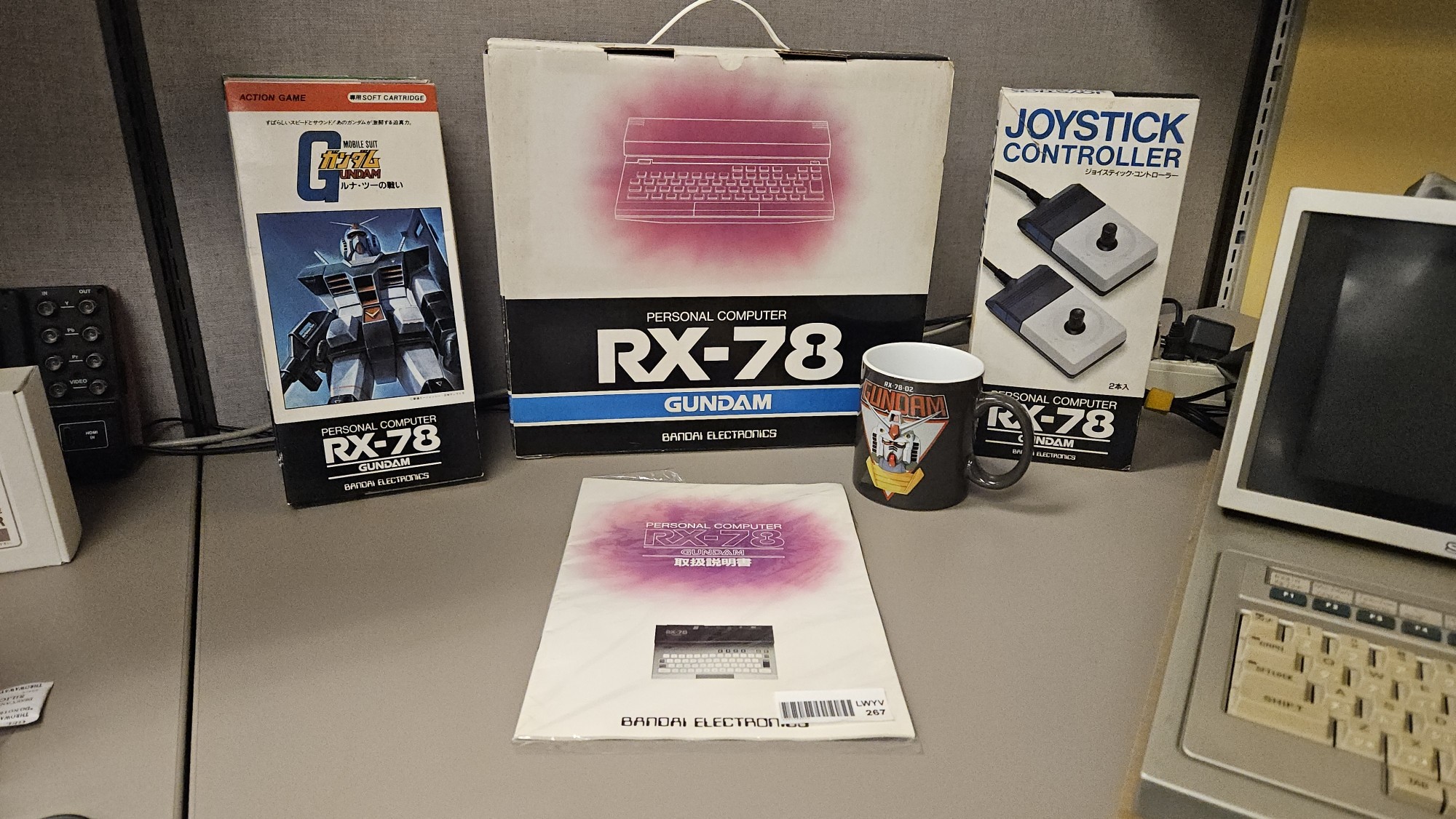Box, manual, joysticks, and game for the Bandai RX-78 personal computer. Bonus Gundam mug as well.